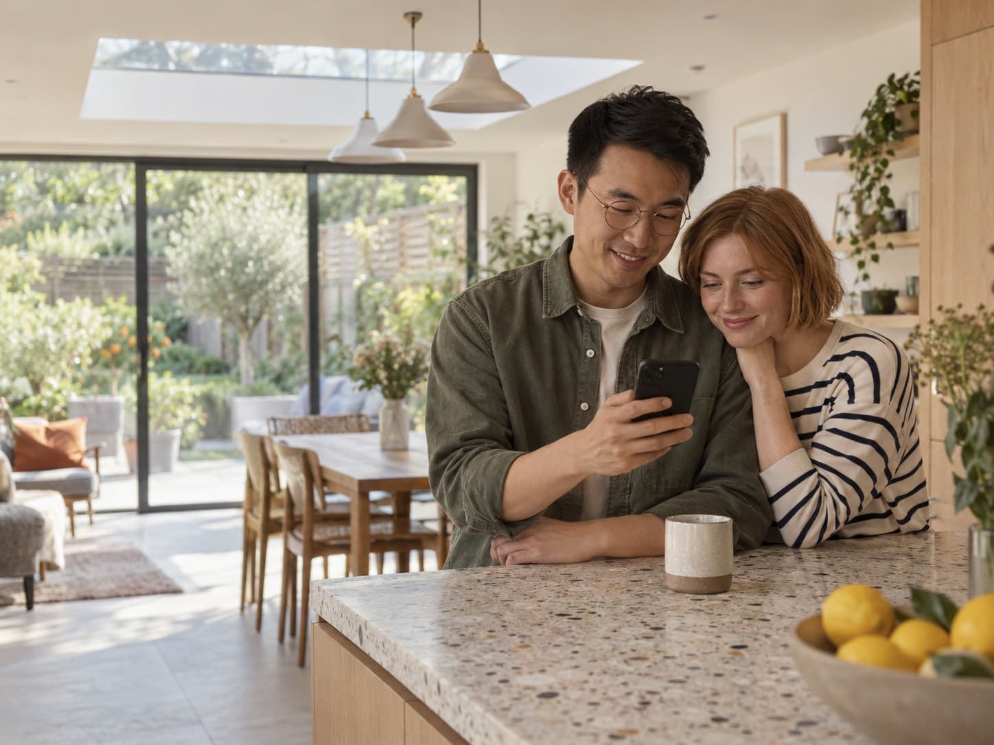 A couple reviewing their project budget together on a phone